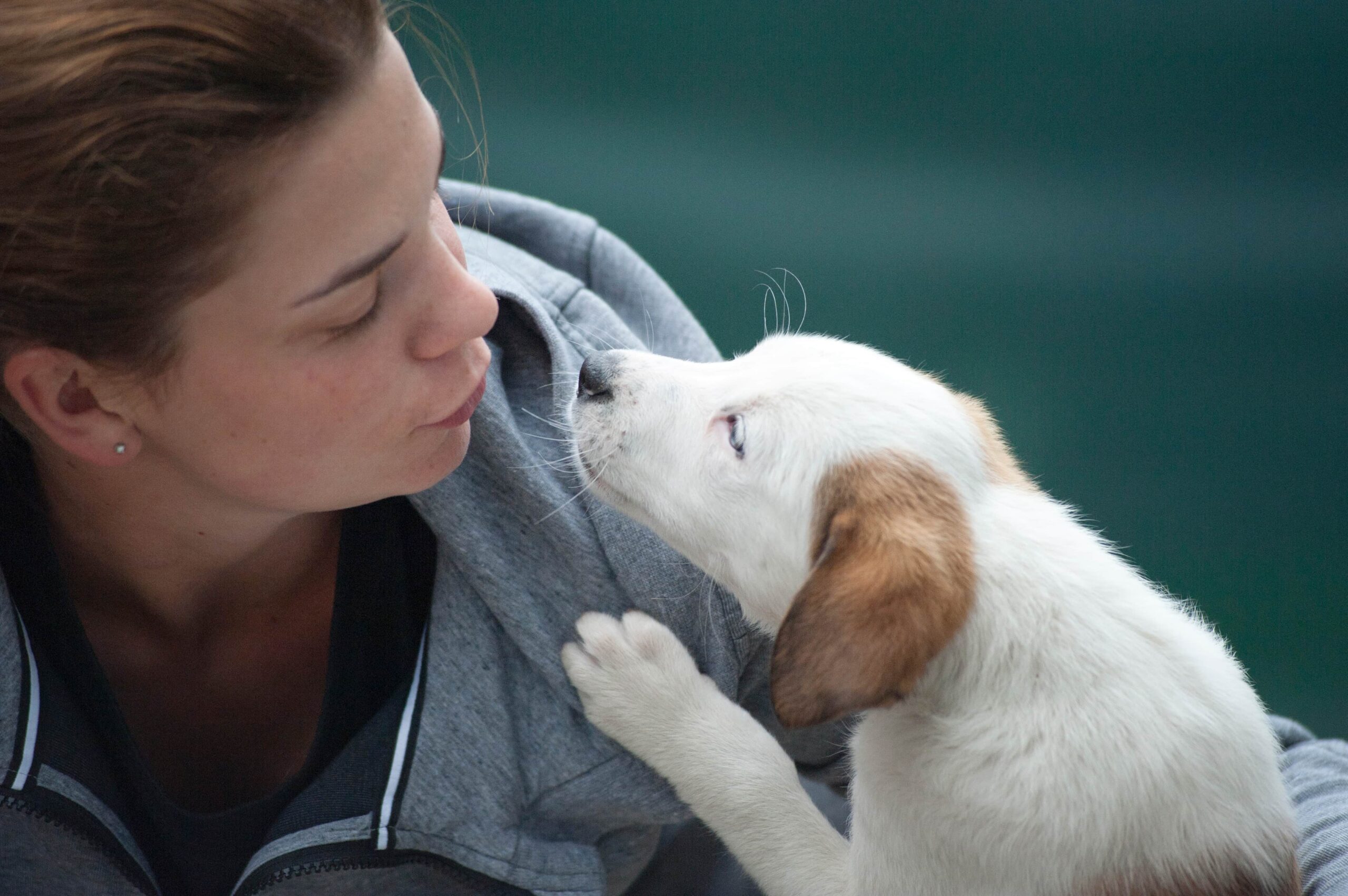 Woman blowing a kiss to her puppy