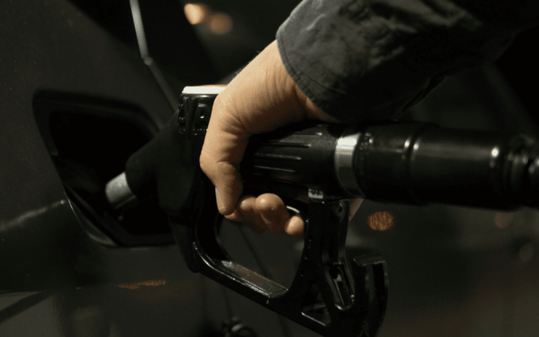 Close up of someone pumping gas into a car