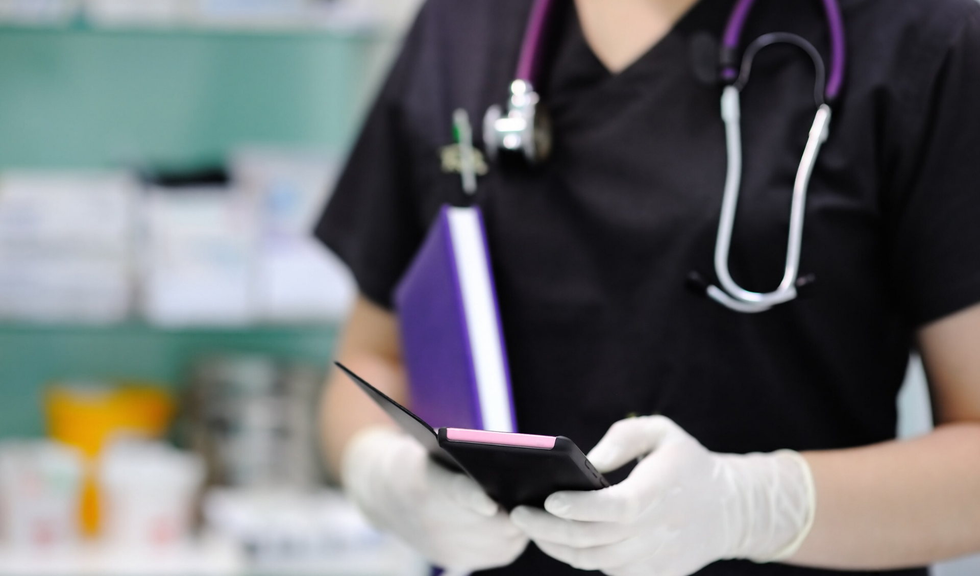 Close up of a veterinarian using their smartphone while wearing gloves