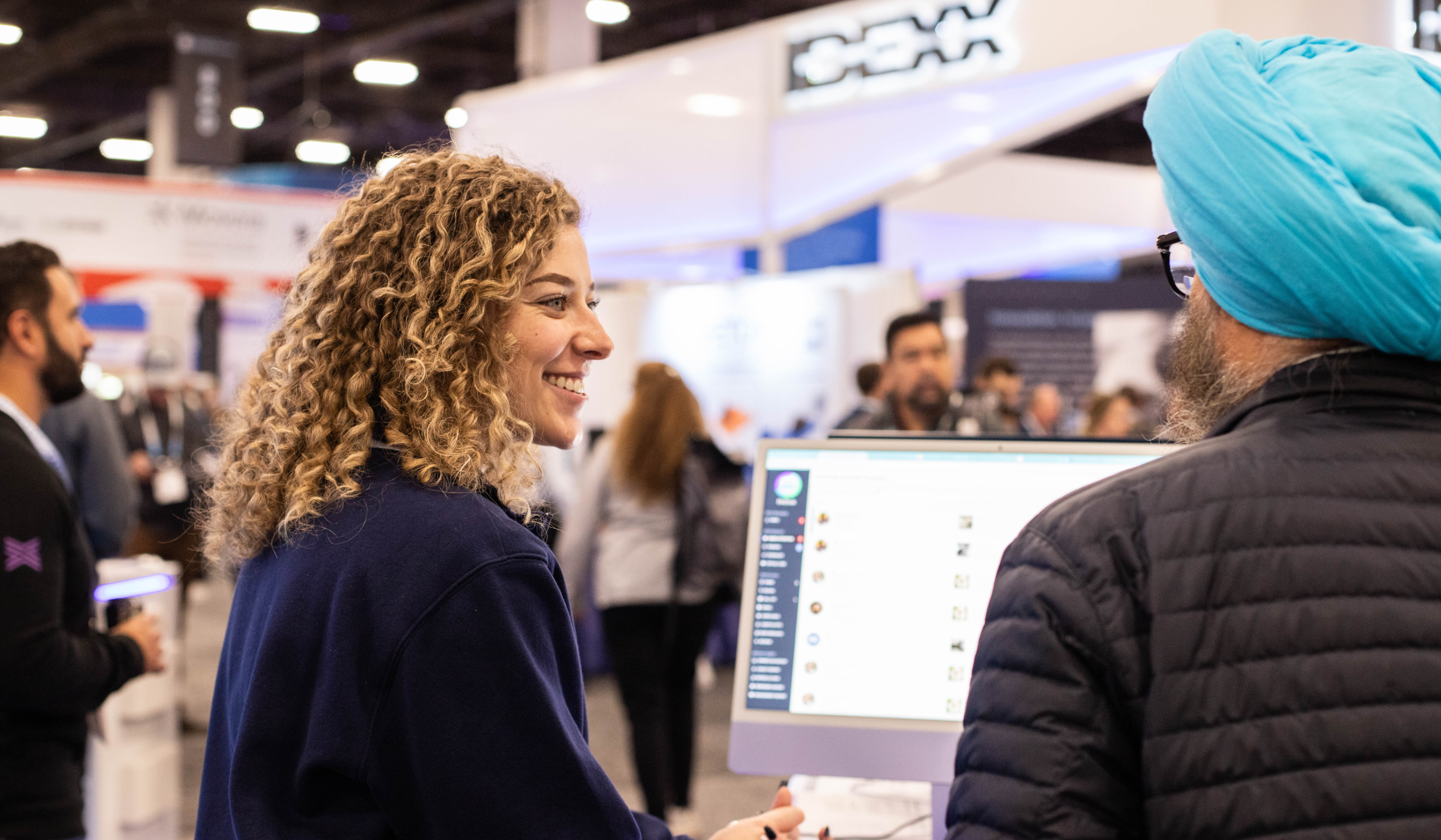 Image of PetDesk SDR happily chatting with a prospect at a conference