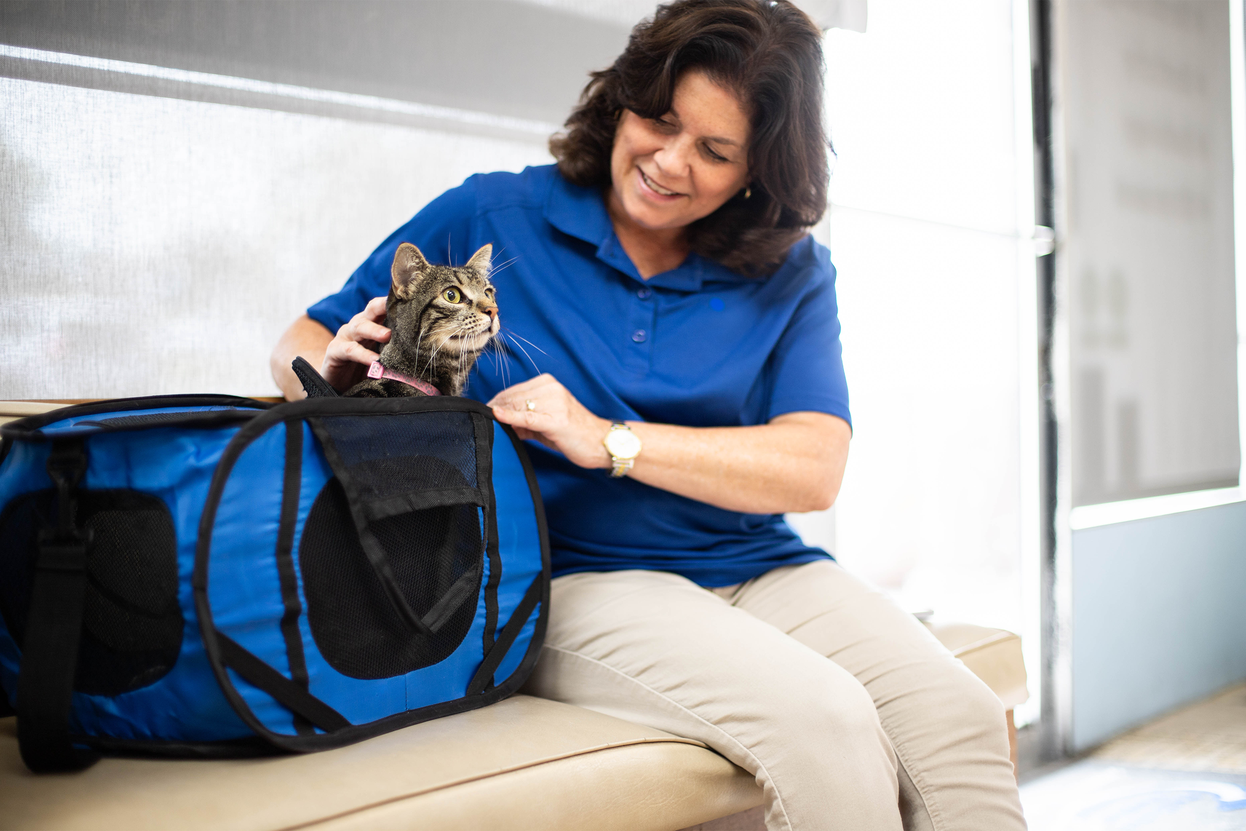 Pet parent sitting in the lobby with their cat waiting for appointment