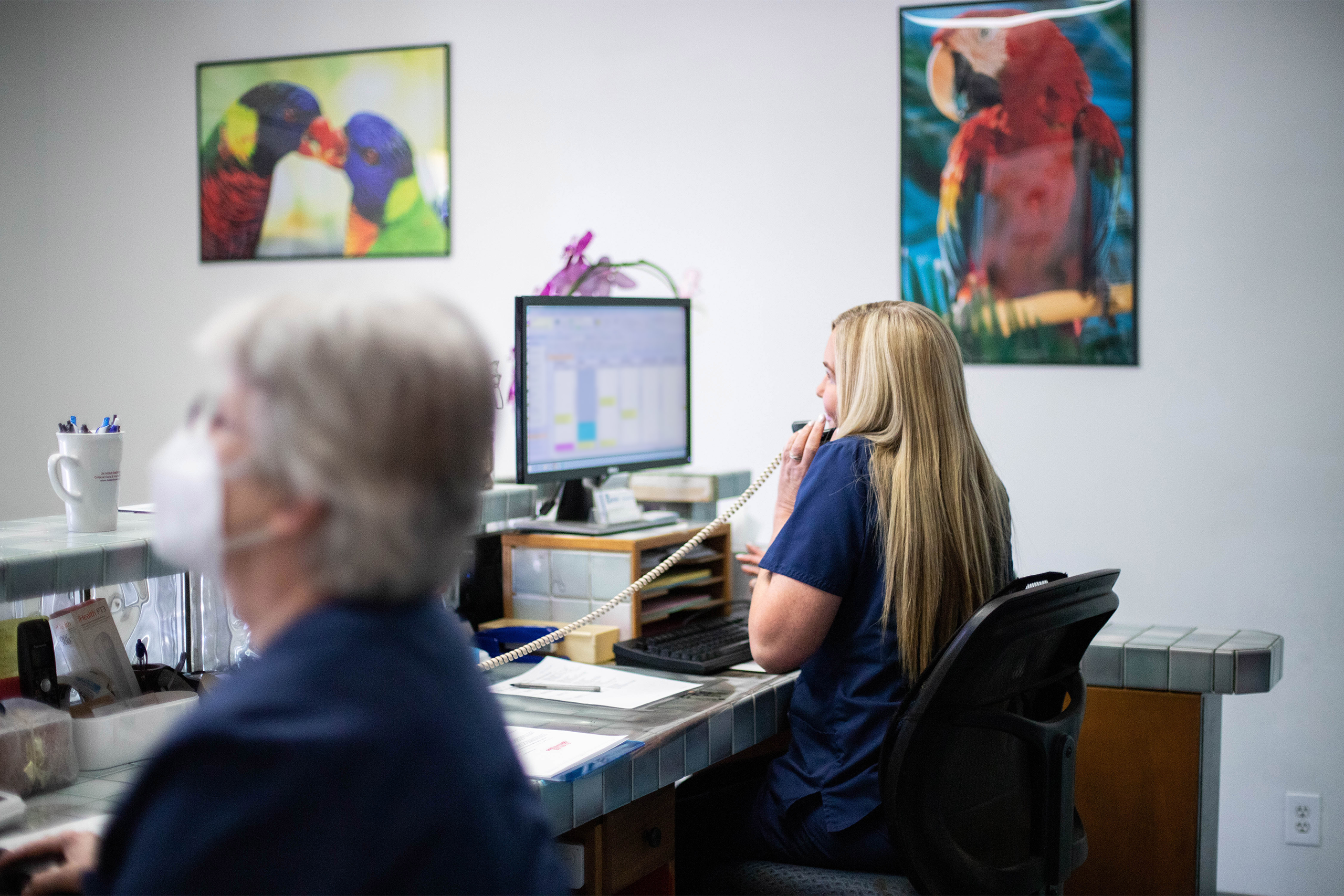 Veterinary CSR Happily chatting on the phone at the front desk