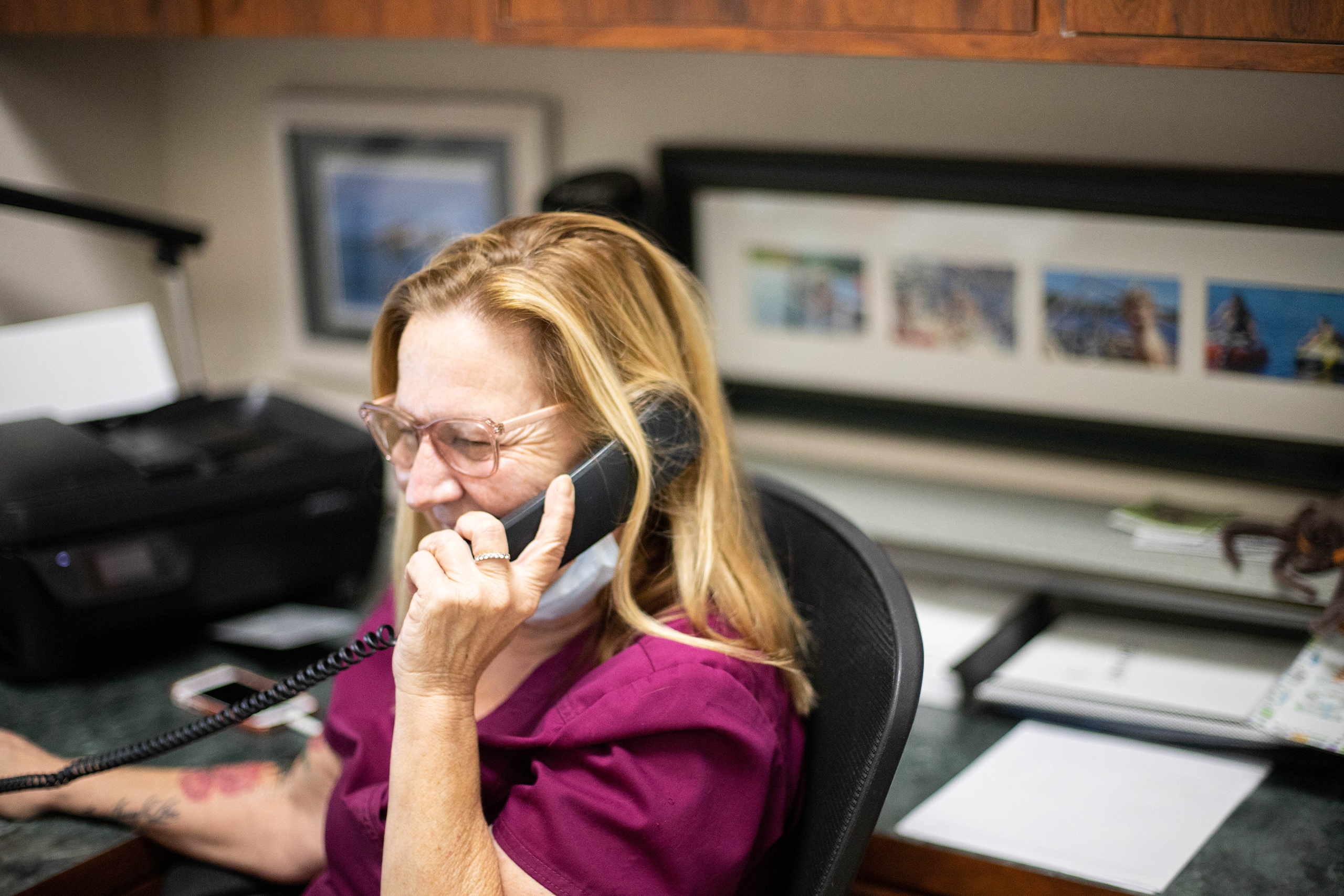 Veterinary PM happily chatting on the phone in their office